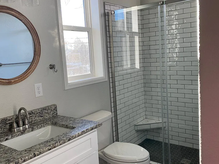 The bathroom has a clean, modern feel. Fixtures and surfaces complement each other creating a spa environment.