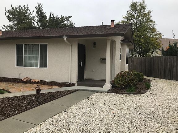 Front door, porch. Living room window Side flowers