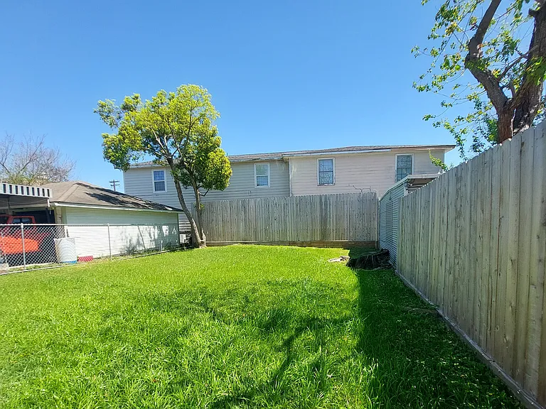 Look at this large back yard, kids running with their pets freely. Big enough for a Bouncy bounce AND you don't have to cut it! Lawncare is included!