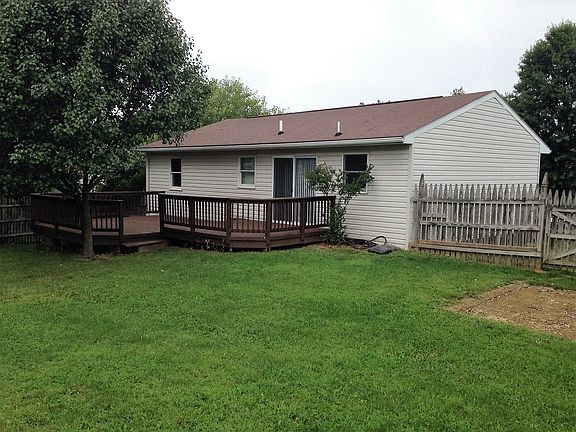 Fence in back yard with large deck