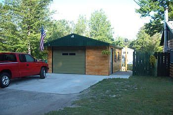Garage with cement driveway, paved rd.