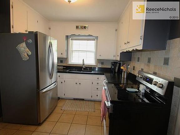 Tidy, Efficient Kitchen Opens To Dining Area