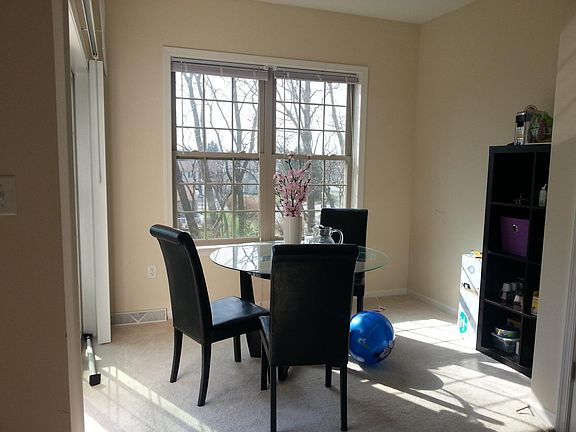 Small sunroom attached to kitchen and breakfast nook and opens to private deck
