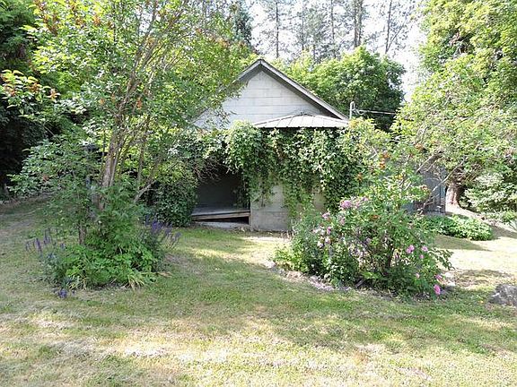 SIDE VIEW OF HOUSE AND YARD.