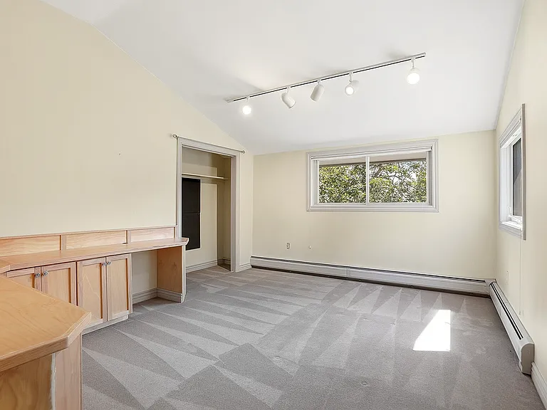 Thoughtfully designed with built-in workspace and storage, this light-filled bedroom offers both practicality and comfort.