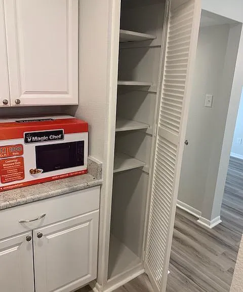 Large pantry with space for a garbage can