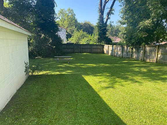 Beautiful large completely fenced in backyard with storage shed and park bench!