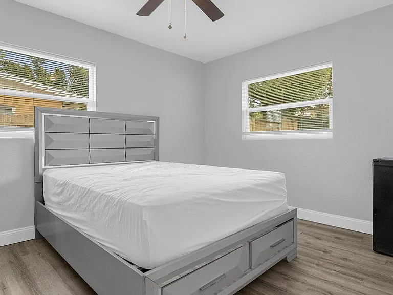Queen bed mini fridge to right