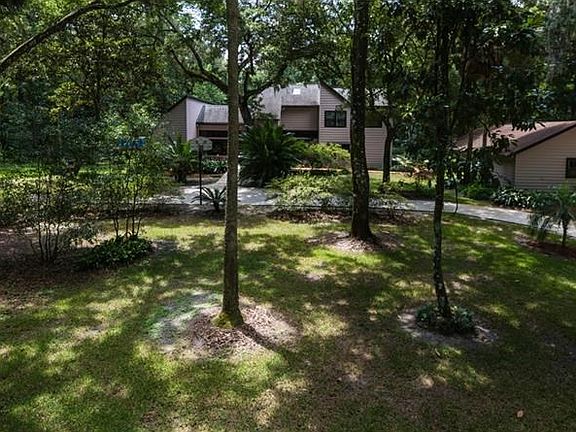 Front, circular driveway, detached garage