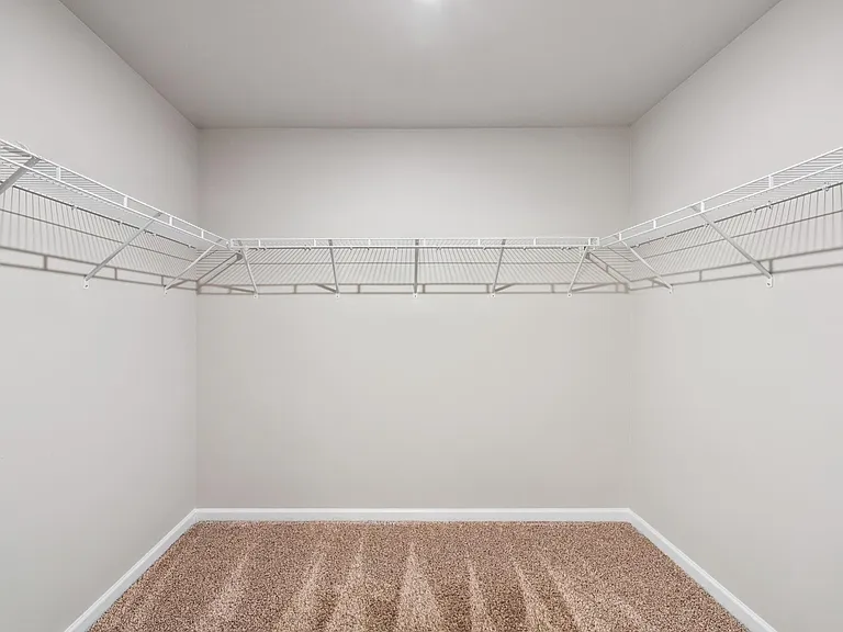 Large walk in closet with plenty of room for His and Hers designer fashion clothes
