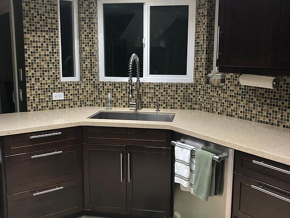 Stainless steel single basin sink and quartz counters.