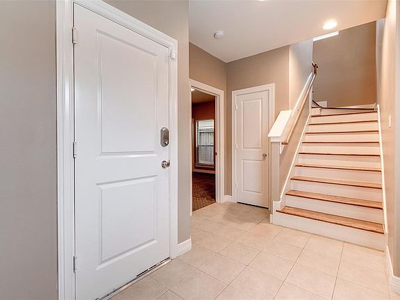The front entry has tile floors, recessed lighting and access to the garage.