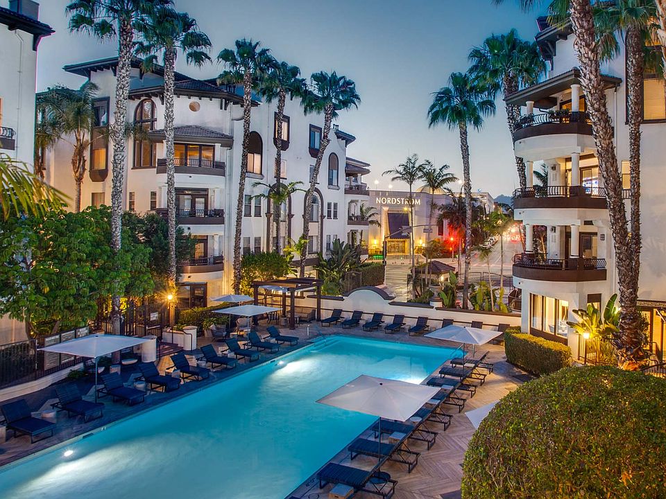 Resort-style saltwater swimming pool with lounge chairs and expansive sundeck