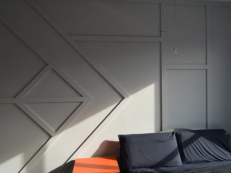 Custom-designed accent wall adds an interesting pop to the room