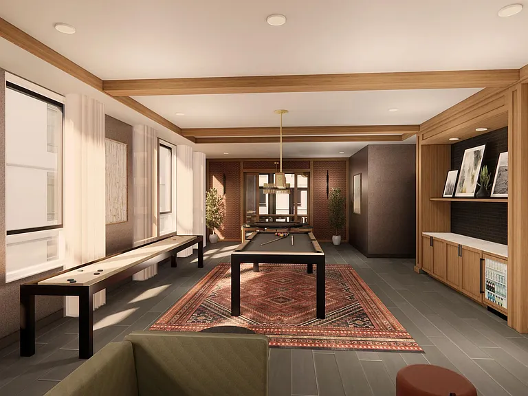 The game room at Modera Bridle Trails pairs a cozy fireplace with warm wood paneling for relaxed evenings and friendly competition.
