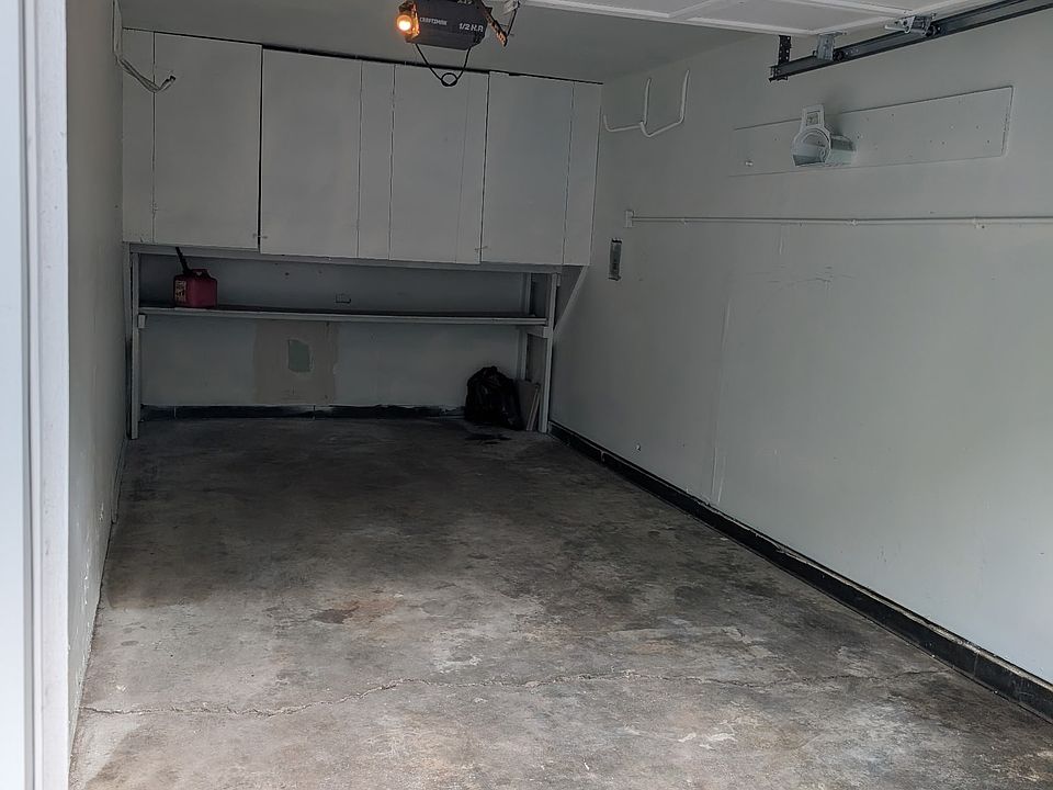 PAINTED GARAGE WITH GARAGE DOOR OPENER AND KEY PAD