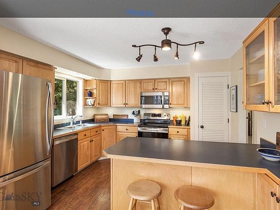 Upgraded kitchen with maple cabinets, dishwasher, pantry, and seating area.