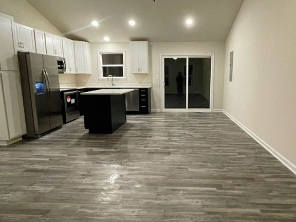 Spacious kitchen and living area.
Windows at front and back, lots of natural light.
Granite counters and island with room for seating. 
Beautiful LVP flooring throughout.