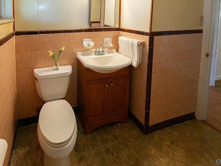 The bathroom. The tub is across the room from the toilet, not in the photo.
