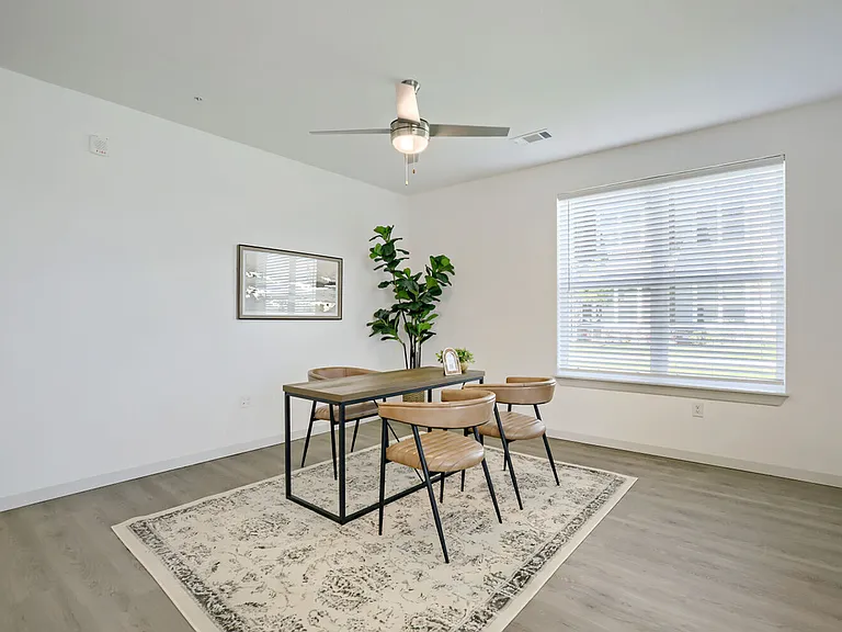 Oversized windows and warm finishes make dining feel like an occasion. Garrett Harvest Junction West _ new apartments in Longmont, CO.