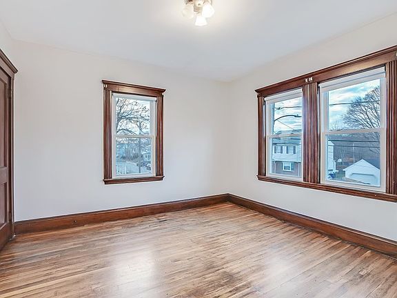 Bedrooms bathed in morning light, oak underfoot and windows that frame the neighboring rooftops. This is one of two matching second-floor bedrooms. Wake easy. Sleep deeply. Live comfortably.