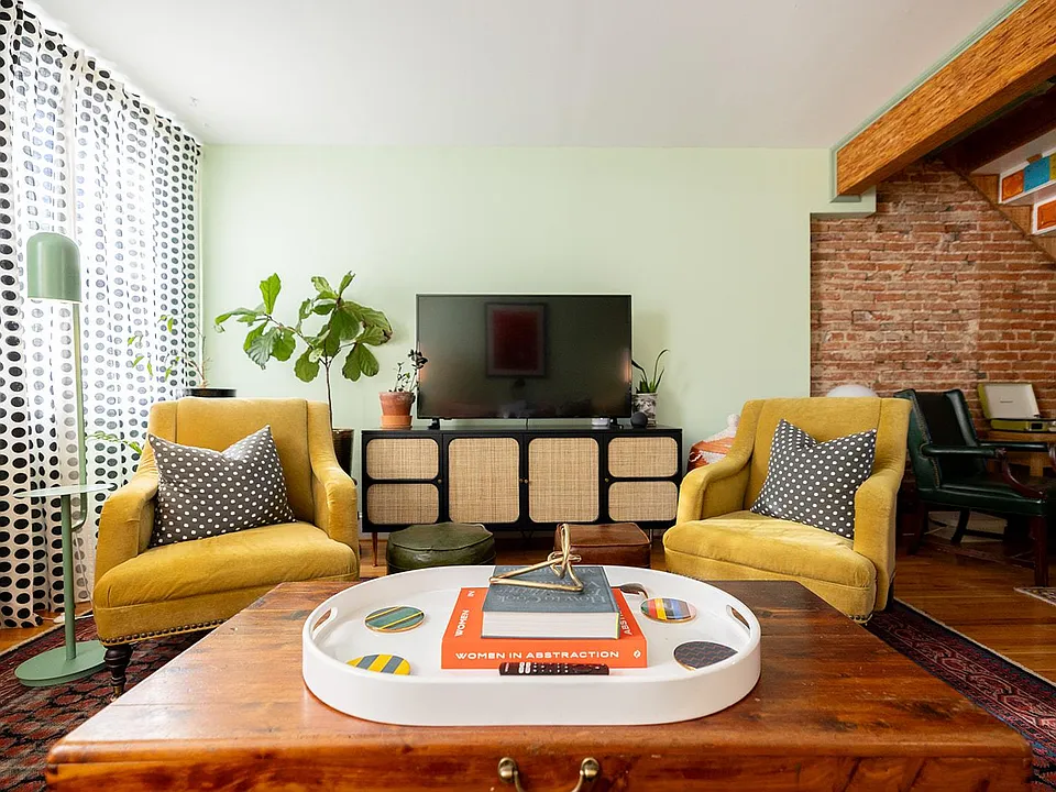 _____ Our versatile living room: spacious sofa, listening nook, and a dedicated office space for productivity.