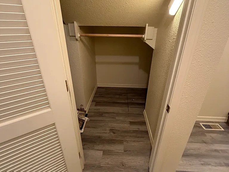 Under stair closet with gas water heater.