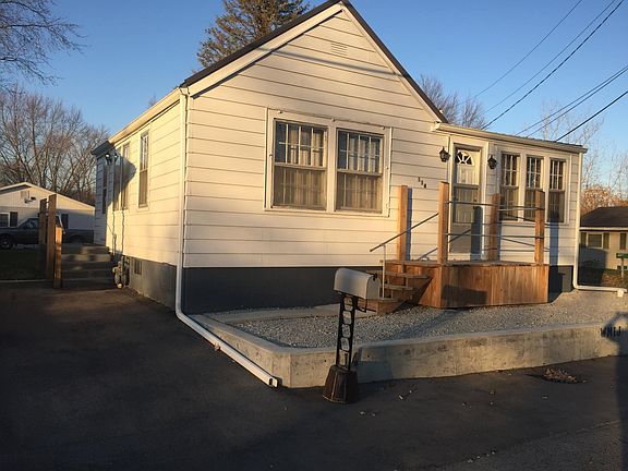 This view shows the driveway and main side entrance to the house into the kitchen area.
