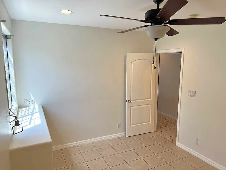 Bedroom 2 has a large closets, ceiling fan, and built in window shelf.