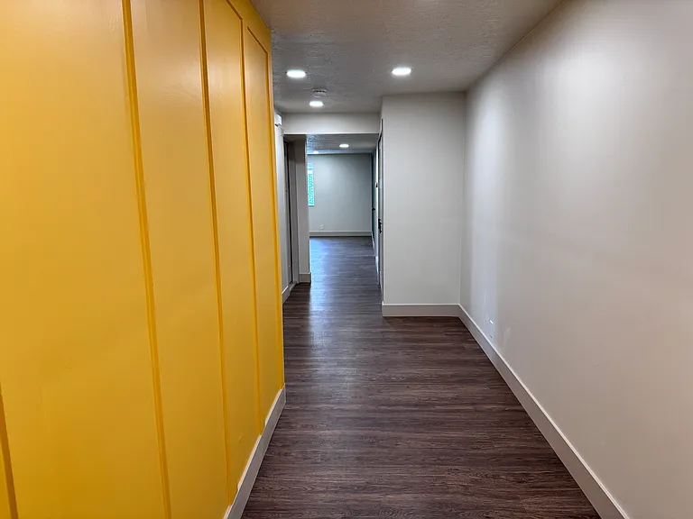 Welcoming entry hallway with modern flooring, recessed lighting, and a clean, open feel.