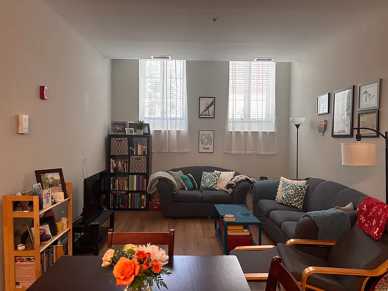 Living room, open to the kitchen with high ceilings.