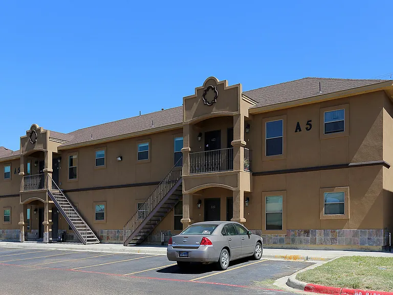 Merida Vista Apartments in Laredo, TX - Exterior Building Apartment A5 with Parked Cars View
