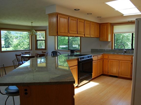 Sitting proud on the 5 acres with amazing views. Nice level entry. Fruit trees, garden areas and multiple fenced areas.