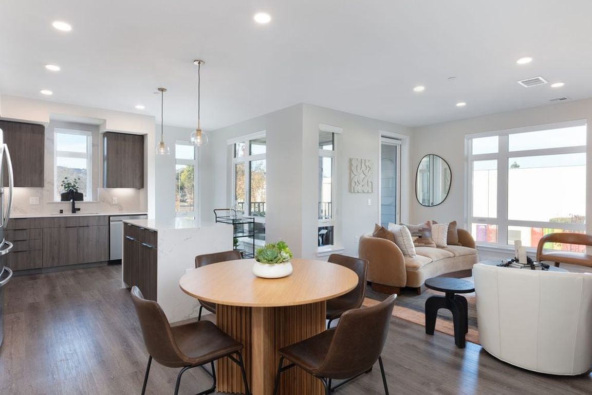 Signature Collection living and dining areas with hard surface flooring throughout