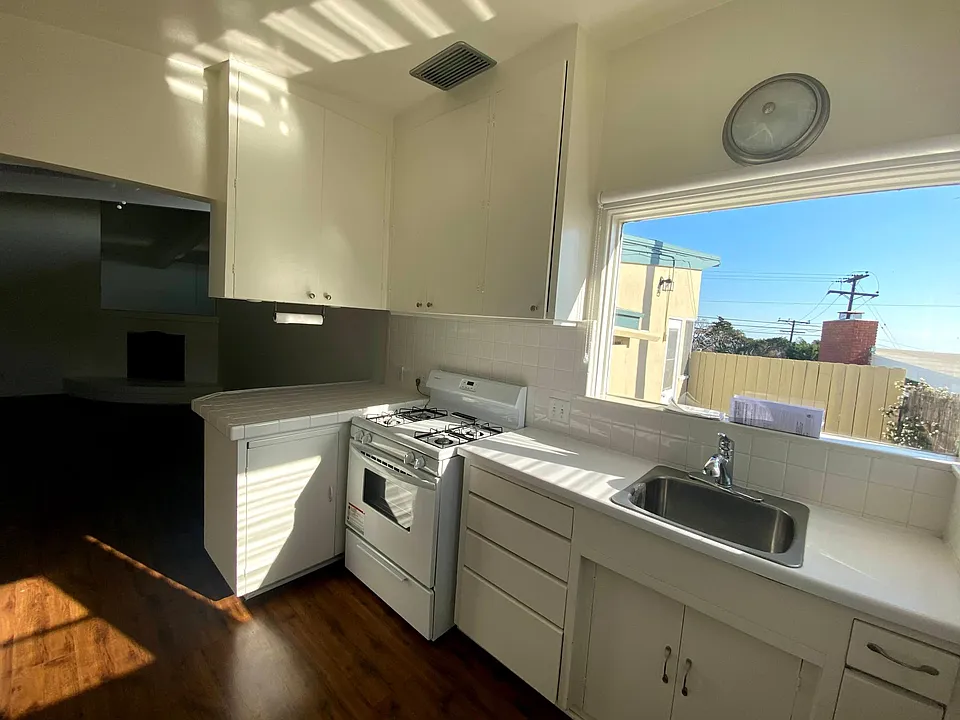 Clean, white kitchen with views