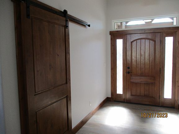 Stained woodwork throughout. Sliding barn door to 3rd bedroom/office
