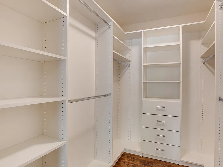 Spacious walk-in closet with built-in shelving and organization