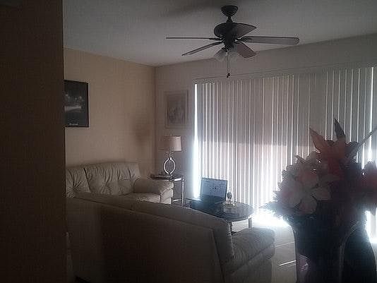 Furnished Living Room With Leather Sofas & Wooden Tables & Lamps