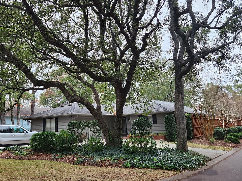 Front of home with beautiful oak trees and circular drive . Ample off street parking