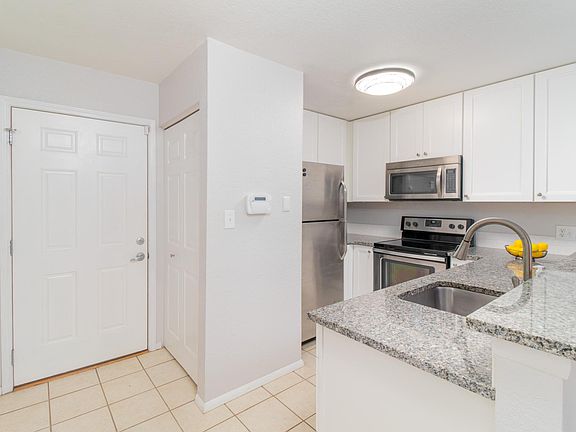 Renovated kitchen with all-stainless appliances and granite countertops