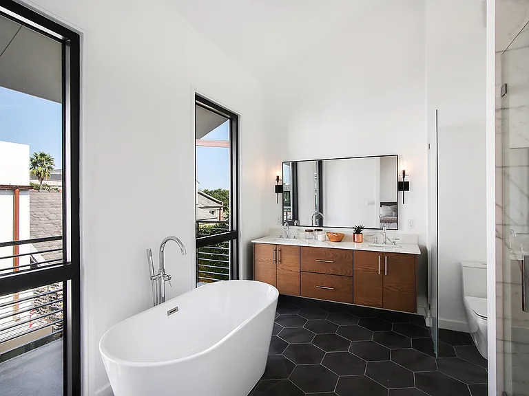 The master bathroom is very spacious and features a free standing bathtub, shower and high end finishes.