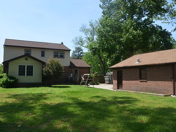 Back of home with garage.