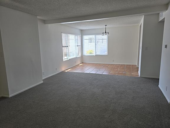 Spacious living room and comfortable dining area with new light fixture. Large southwest facing windows.