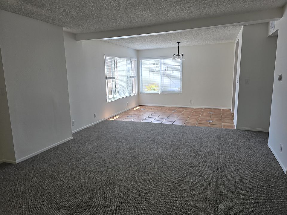 Spacious living room and comfortable dining area with new light fixture. Large southwest facing windows.