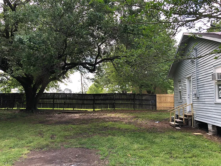 Large yard partially fenced.
