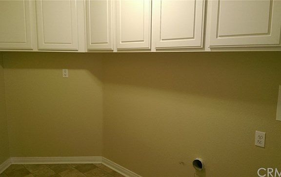 Laundry is a large room with plenty of extra storage space.