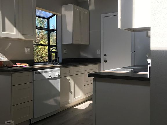 Kitchen with dishwasher and quartz countertops.