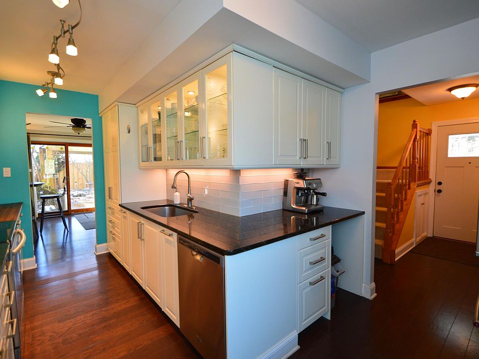 Updated kitchen with glass tile backsplash and granite counters