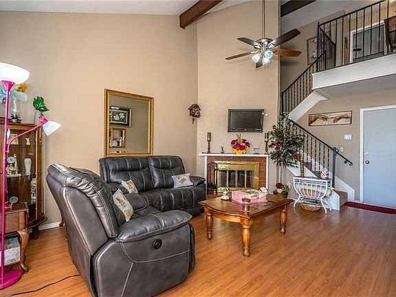Open-concept living area enhanced by updated banister framing spacious staircase