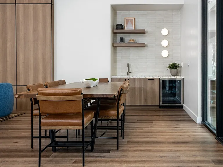Built-In Lounge Kitchen with Sleek Cabinets, Floating Shelves, and Mini Fridge